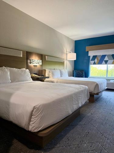 a hotel room with two beds and a window at Holiday Inn Express & Suites San Antonio South by IHG in San Antonio