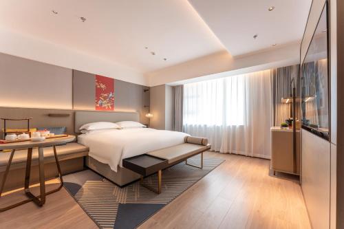 Ένα ή περισσότερα κρεβάτια σε δωμάτιο στο Yicheng Hotel, Jianghan Road Pedestrian Street, Wuhan River Beach