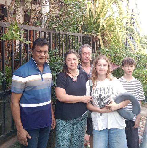 a group of people standing in front of a fence at Innovick Residence in Kandy