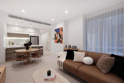 a living room with a couch and a table at 'CoCo' 2-BR Apt in the heart of Burwood with free parking in Sydney