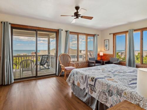 a bedroom with a bed and a balcony at 2030 - Horizon`s Summit in Duck