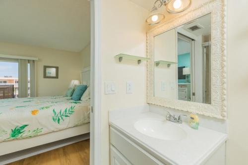 a bathroom with a sink and a bedroom with a bed at St Augustine Beach Tennis 405 New in Saint Augustine
