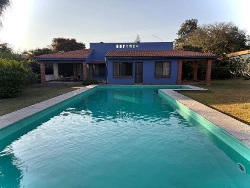 a swimming pool in front of a house at The Weiss House - Mountain, Pool and Rest in Tepoztlán