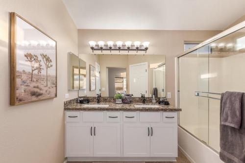 a bathroom with a sink and a mirror at 136th Surprise in Surprise