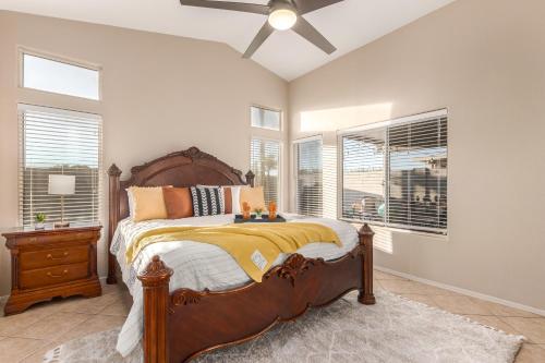 a bedroom with a bed and a ceiling fan at 136th Surprise in Surprise