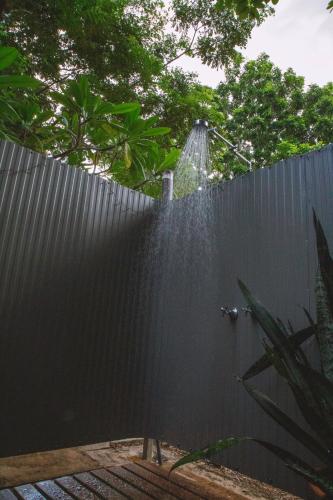 a fence with a shower in the backyard at Mt Bundy Station in Adelaide River