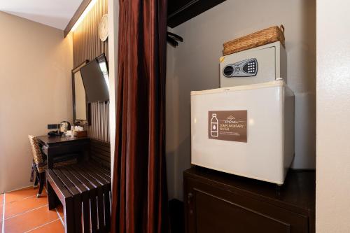 a television sitting on top of a dresser in a room at Baan Sukhumvit Soi 20 in Bangkok
