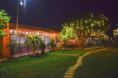 a house with a walkway in the yard at night at Phúc Hưng Homestay- Venuestay in Ba Vì