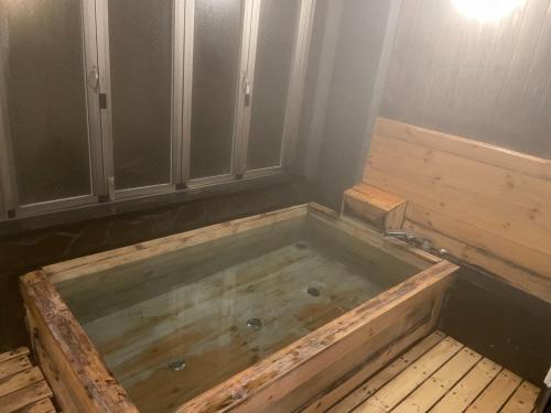 an empty tub in a room with at Hotel Nissin Kaikan - Vacation STAY 85724v in Shiso
