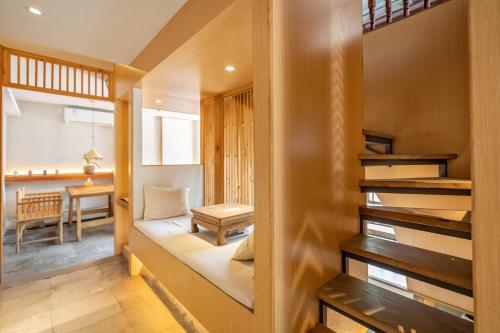 a small room with a stairway leading to a living room at cloud and wind in Yangzhou