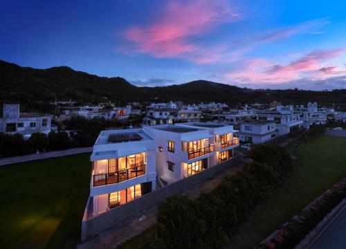 an aerial view of a large white house at dusk at クリスタル別荘南城 in Nanjo