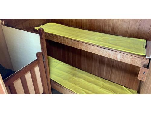two bunk beds with green sheets on them at Hotel Nissin Kaikan - Vacation STAY 02361v in Shiso