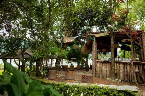 a wooden building with a bar in a garden at Krazy Gecko Resort in Pokhara