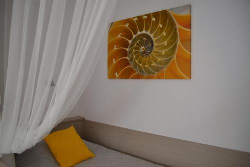 a room with a yellow pillow and a picture on the wall at Brother's Hotel in Ios Chora