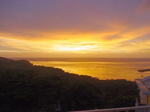 a sunset over the ocean with the sun setting at A Seascape Guest Room in Fajardo