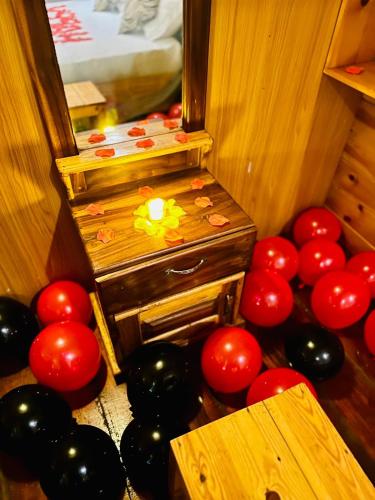 a room with red and black balloons and a candle at Sasvi Cabana in Trincomalee