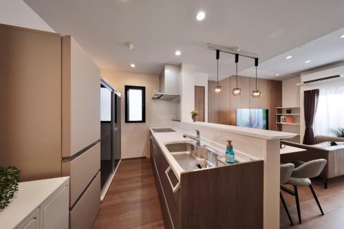 a kitchen with a sink and a refrigerator at クリスタル別荘南城 in Nanjo