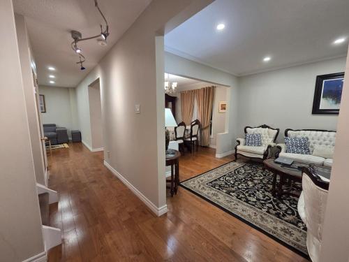 a living room with a couch and a table at Three Bedrooms House in Mississauga with free parking Conveniently located with easy access to the airport downtown Toronto major malls and highways for a seamless stay in Mississauga