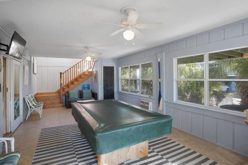 a living room with a large green bed in it at Sprawling Family Home w/ Pool Table - Steps from Beach, Tennis, & Pools in Fripp Island