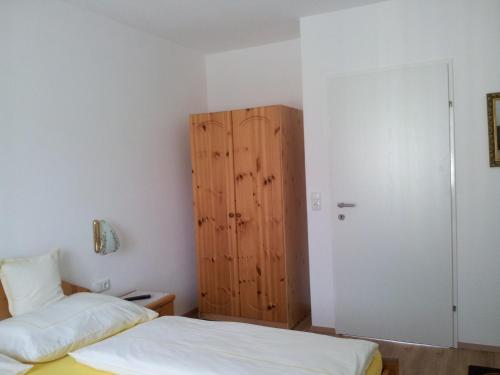 a bedroom with two beds and a wooden cabinet at Haus Amalia in Strobl