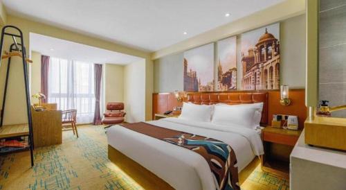 a hotel room with a large bed and a desk at James Joyce Coffetel· Xianyang Renmin Road Central Square Store in Xianyang