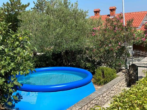 a large blue tub sitting in a garden at Holiday home in Klimno - Insel Krk 42238 in Klimno