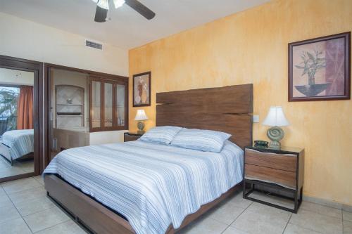 a bedroom with a large bed with a wooden headboard at Sonoran Sky in Puerto Peñasco