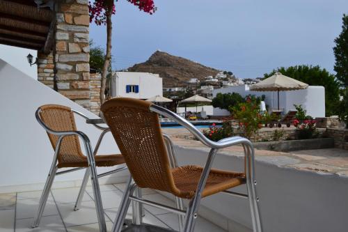 two chairs and a table on a balcony at Brother's Hotel in Ios Chora
