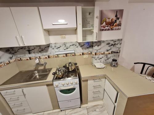 a small kitchen with a sink and a stove at Kallpa in Cusco
