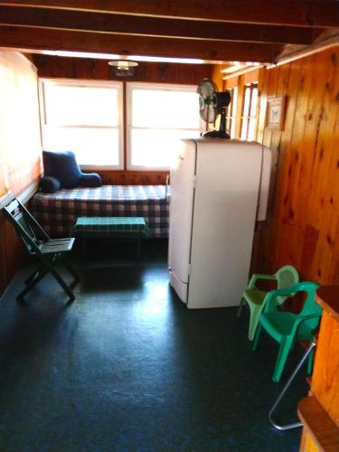 a living room with a refrigerator and a couch at Idylwild-lake Area in Bass Lake