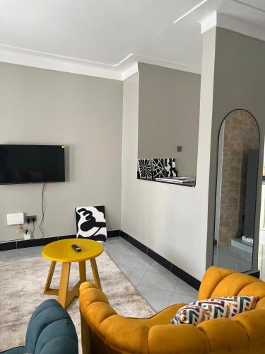 a living room with a couch and a table at Comfy Urban Haven in Nalakonge