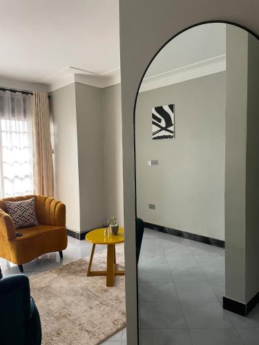 a living room with a couch and a mirror at Comfy Urban Haven in Nalakonge