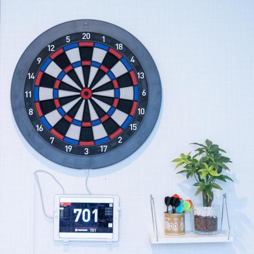 a dart board hanging on a wall with a clock at エイトハウス辻 in Naha