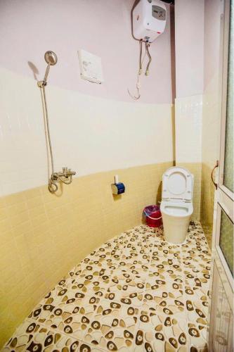 a bathroom with a toilet and a shower in it at Mộc House in Mộc Châu