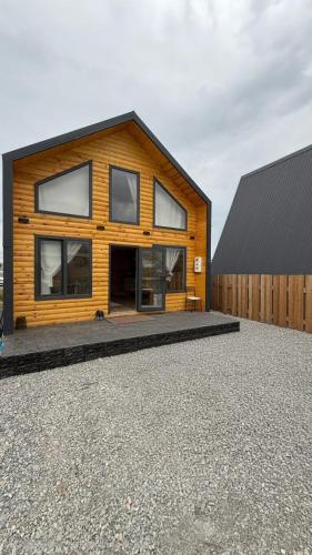 a wooden house with a black roof at BarNWooD in Cholpon-Ata