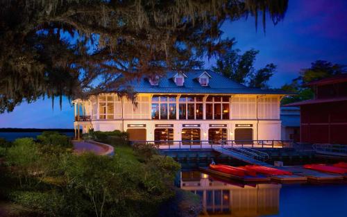a large house with boats in the water at night at Signature 5 Bedroom Lagoon Residence 1003 in Bluffton