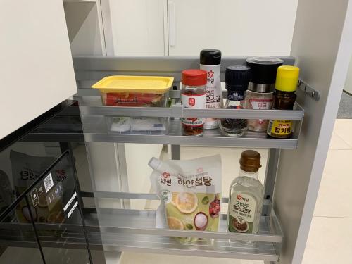 an open refrigerator filled with food and condiments at Lotte Tower view terrace house in Seoul