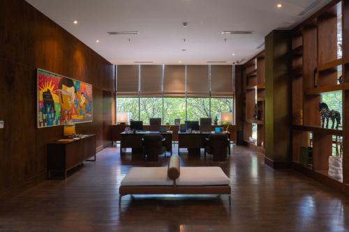 a lobby with a restaurant with a table and chairs at Veranda Hotel Pakubuwono in Jakarta