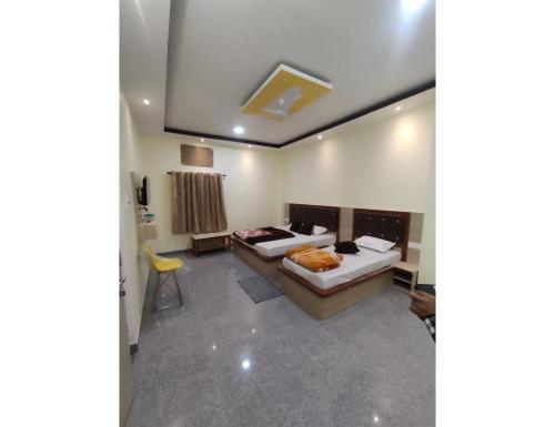a bedroom with two beds in a room at Hotel Chandralok, Chitrakoot in Chitrakoot