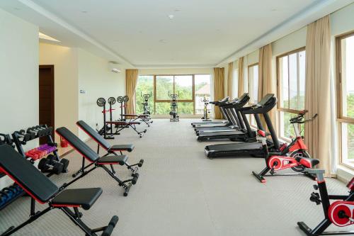 a gym with rows of exercise bikes and treadmills at Treetop by Eight Continents, Zanzibar in Mchangani