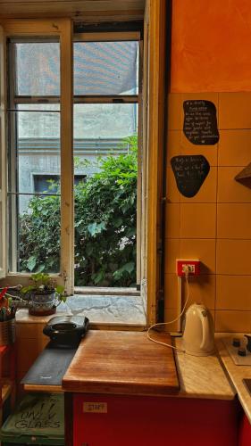 a kitchen with a window and a counter with a sink at Hostel Taormina Homstel in Taormina