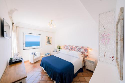 a bedroom with a bed and a living room at Villa Anfitrite in Positano