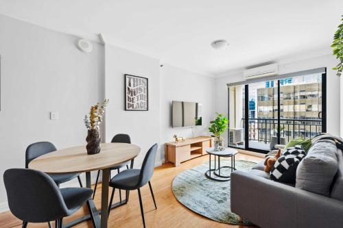 a living room with a couch and a table at Skyline Stay Central 2 Bed Apartment in Perth