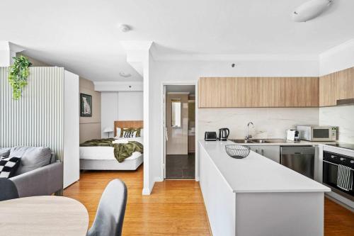 a kitchen and a living room with a bed at Skyline Stay Central 2 Bed Apartment in Perth