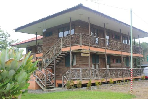 a wooden house with wooden stairs in front of it at Villas Maria Luisa in Uvita