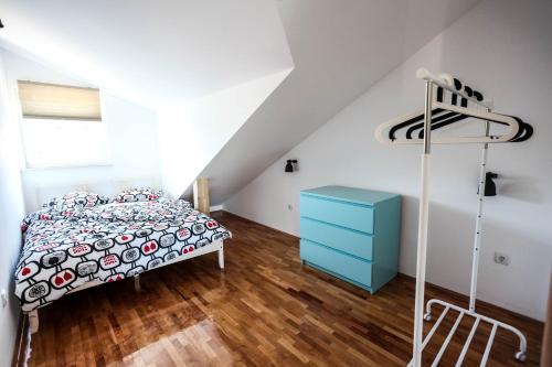 - une chambre avec un lit et une commode bleue dans l'établissement Apartments Rajna, à Žaborić