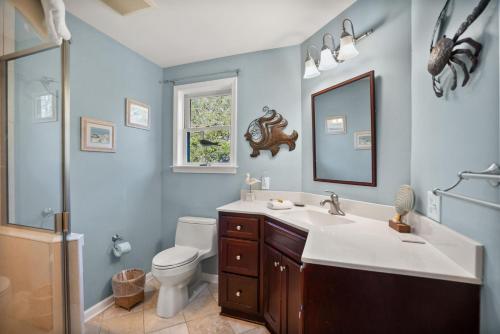 a bathroom with a sink and a toilet and a mirror at 368 Wahoo Dr in Fripp Island