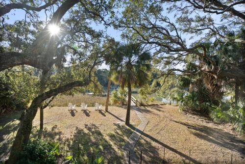 a group of birds sitting in a park under trees at 368 Wahoo Dr in Fripp Island
