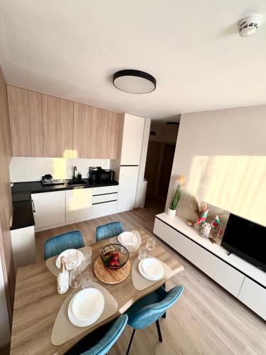 a kitchen and dining room with a table and chairs at Sorrento E 4 4 Sveti Vlas in Sveti Vlas