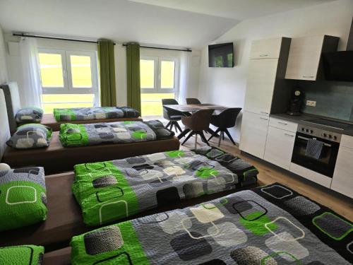 a living room with two beds and a kitchen at Speedys Bed & Breakfast in Reimerath